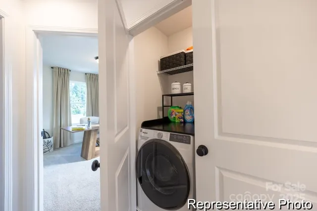 a view of a hallway with washer and dryer