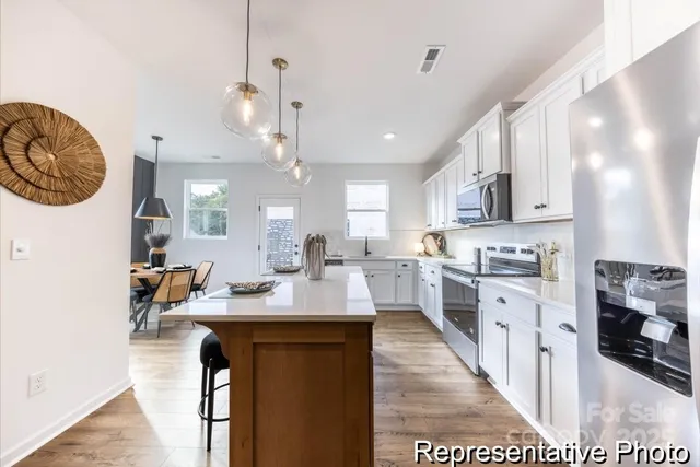 a kitchen with cabinets a sink and appliances