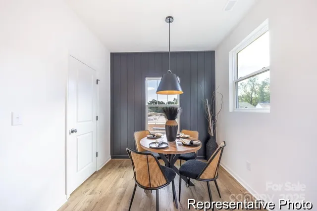 a view of a dining room with a table and chairs