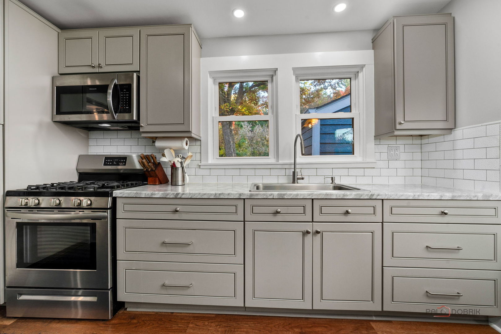 39113 North Cedar Crest Drive Lake Villa, IL 60046 - Photo 7 of 22 a kitchen with white cabinets and appliances