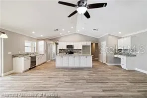 a kitchen with a sink stove and cabinets