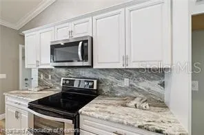 a kitchen with a sink and chandelier