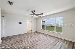 a bathroom with a granite countertop sink a mirror and a shower