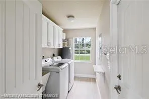 a room with white cabinets and window