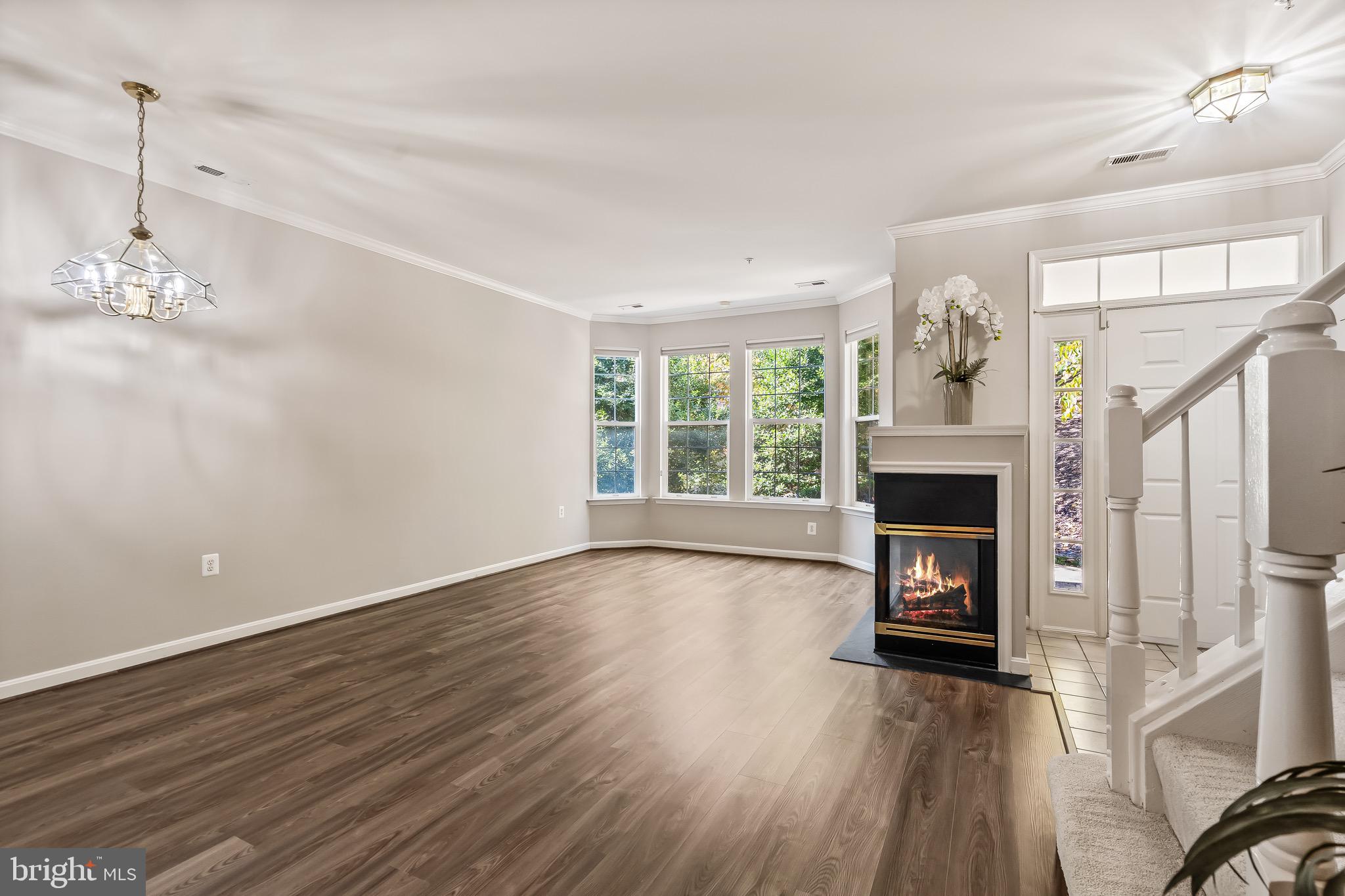 11408 Gate Hill Place, Unit 113 Reston, VA 20194 - Photo 11 of 30 a view of empty room with fireplace and wooden floor