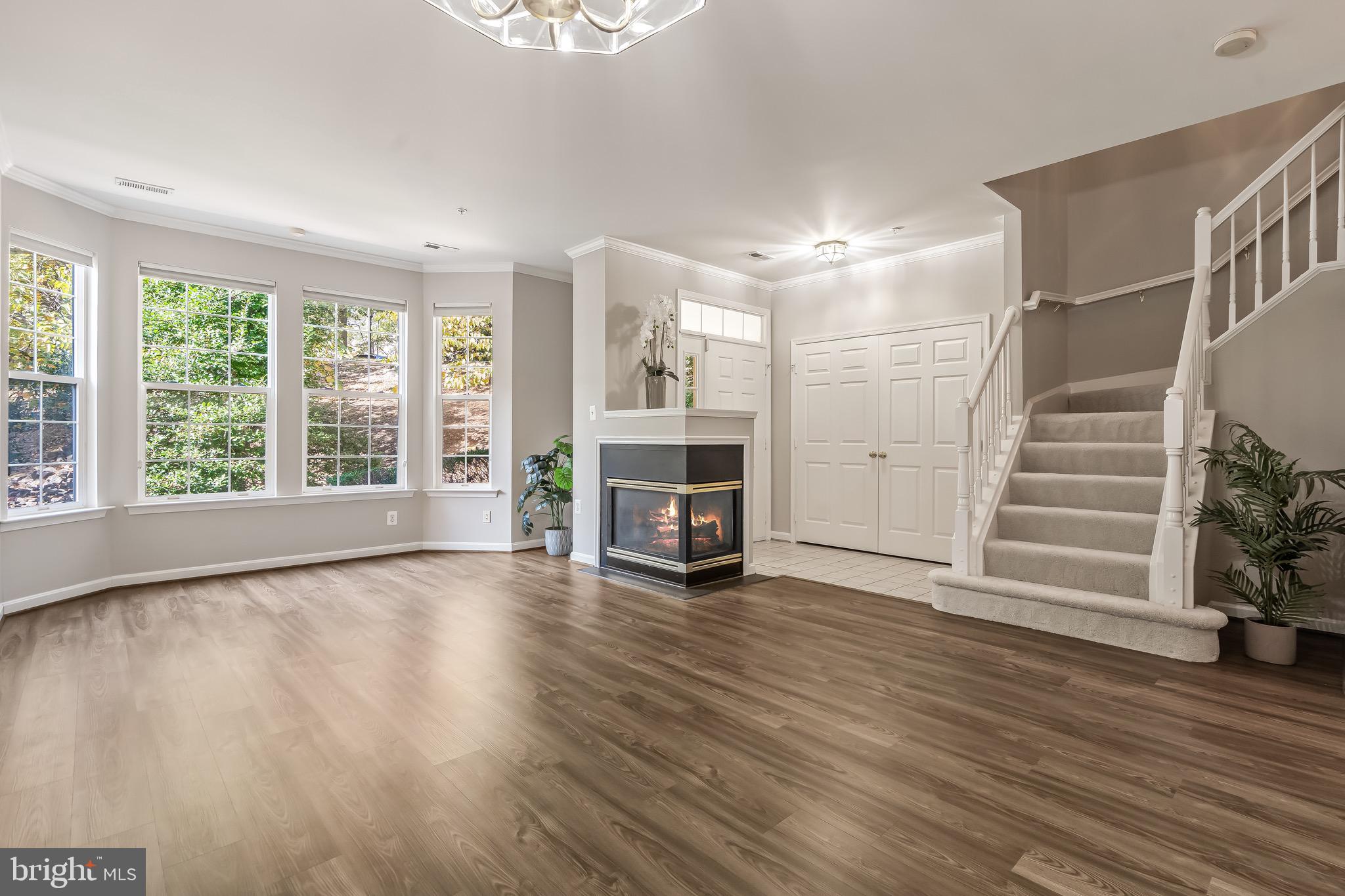 11408 Gate Hill Place, Unit 113 Reston, VA 20194 - Photo 12 of 30 an empty room with wooden floor and fireplace