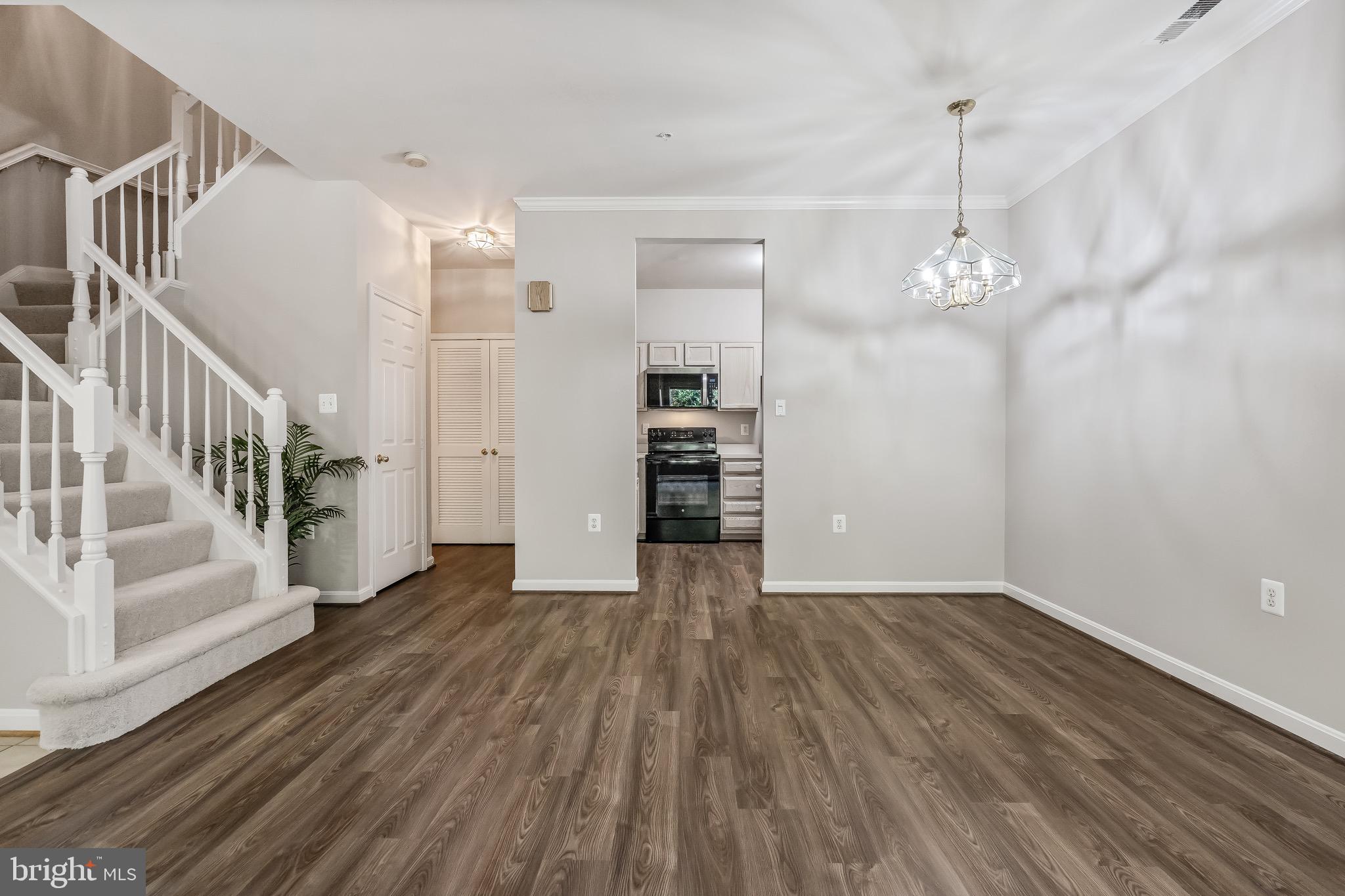 11408 Gate Hill Place, Unit 113 Reston, VA 20194 - Photo 13 of 30 a view of a livingroom with wooden floor