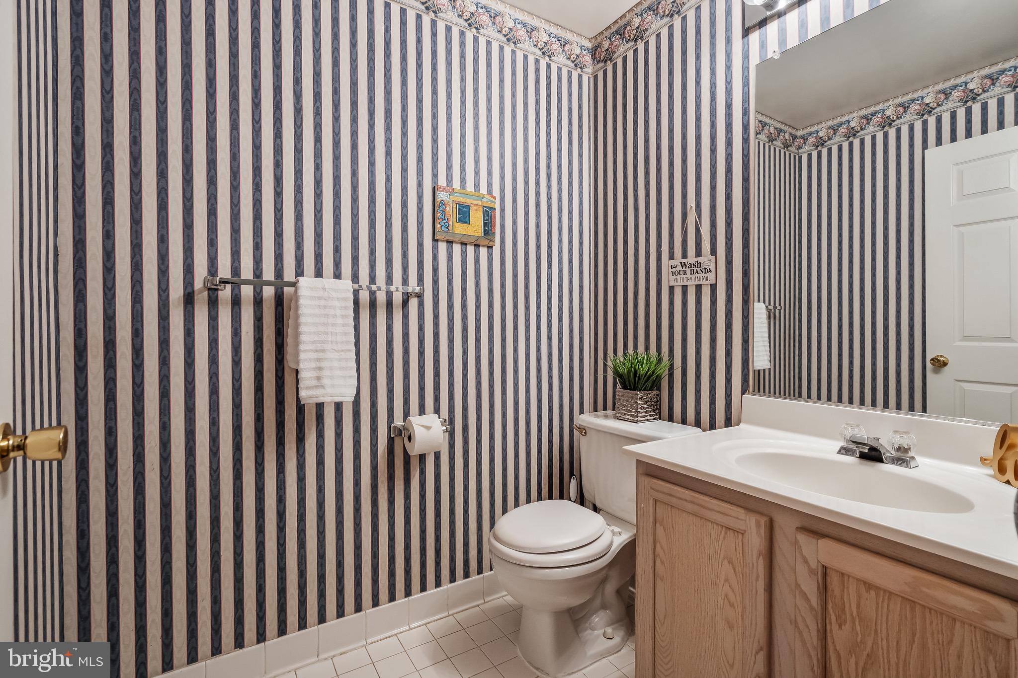 11408 Gate Hill Place, Unit 113 Reston, VA 20194 - Photo 14 of 30 a bathroom with a sink a toilet and vanity