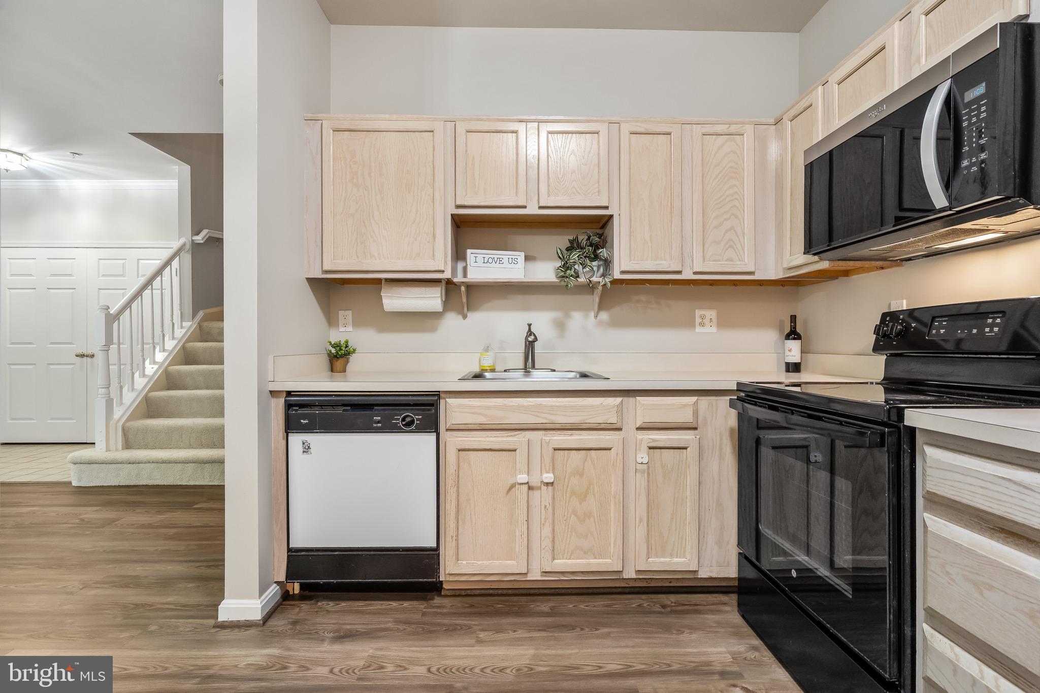 11408 Gate Hill Place, Unit 113 Reston, VA 20194 - Photo 15 of 30 a kitchen with stainless steel appliances granite countertop a stove and white cabinets