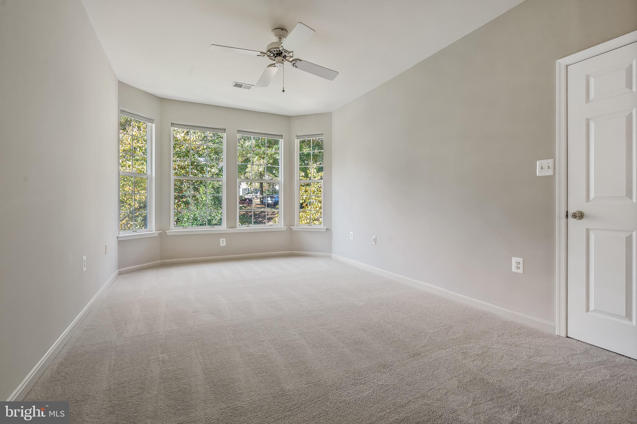 11408 Gate Hill Place, Unit 113 Reston, VA 20194 - Photo 20 of 30 a view of a big room with windows and chandelier fan