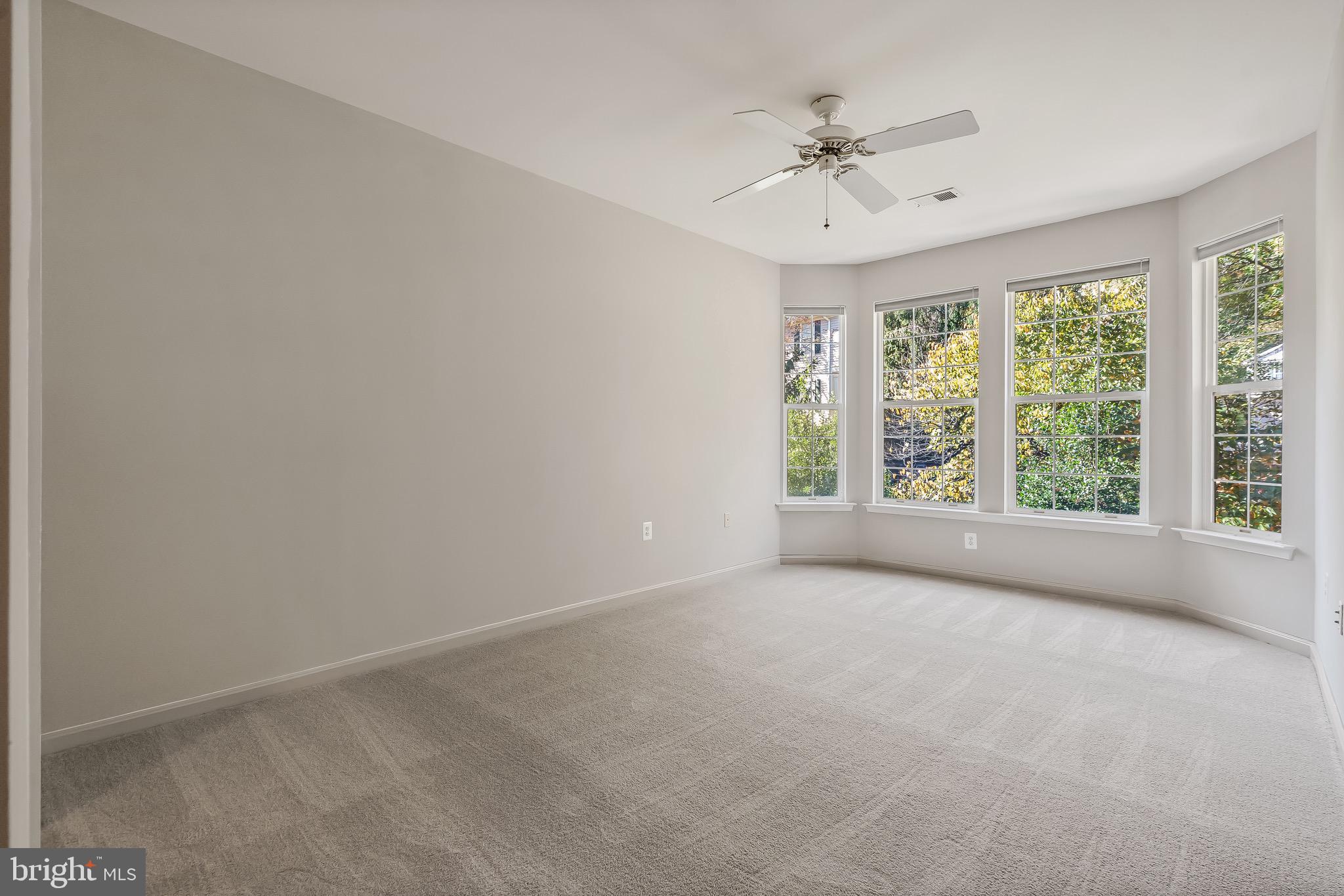11408 Gate Hill Place, Unit 113 Reston, VA 20194 - Photo 21 of 30 an empty room with a ceiling fan and window