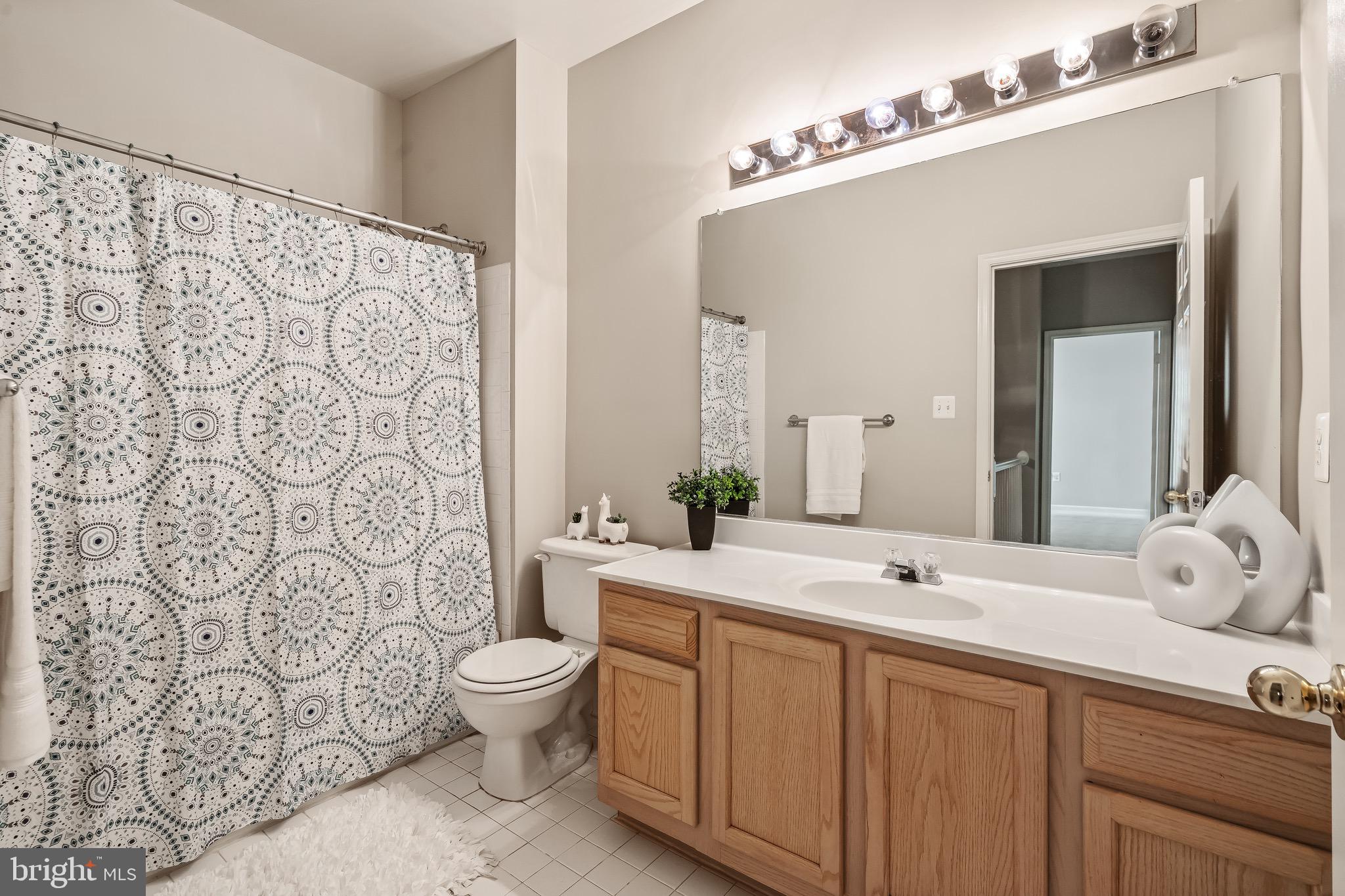 11408 Gate Hill Place, Unit 113 Reston, VA 20194 - Photo 30 of 30 a bathroom with a sink and a mirror