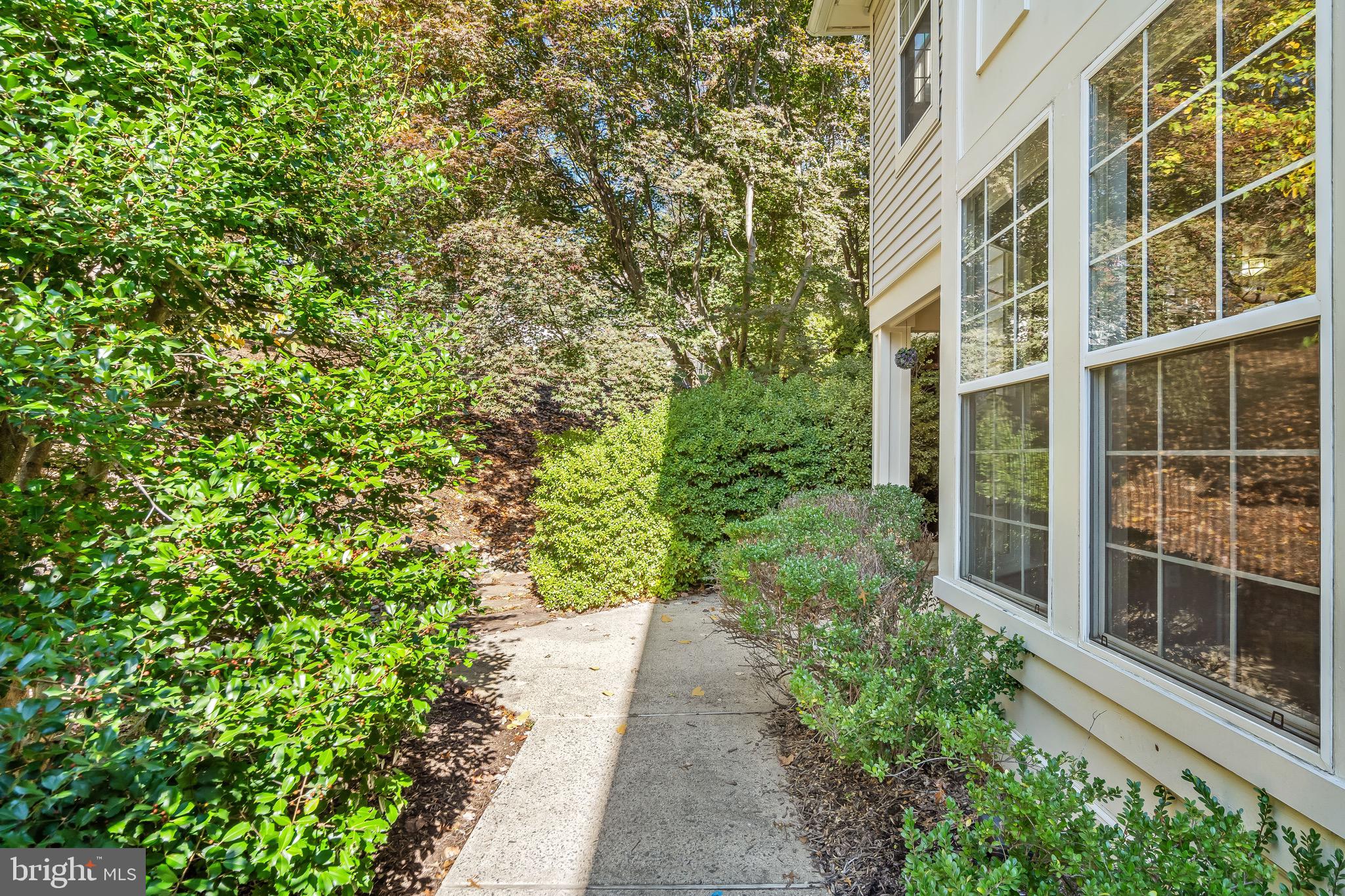 11408 Gate Hill Place, Unit 113 Reston, VA 20194 - Photo 3 of 30 a view of a pathway both side of the house