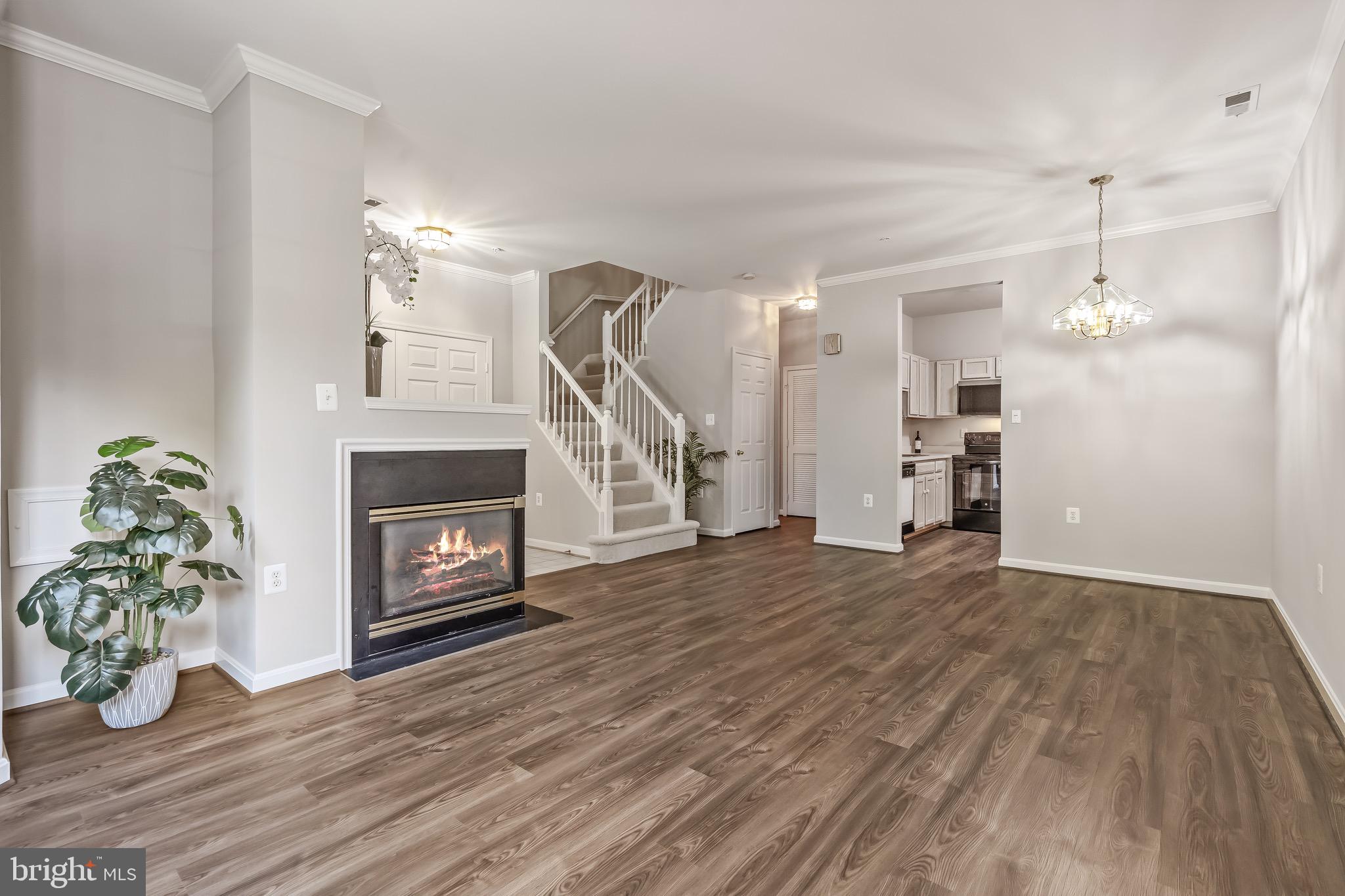 11408 Gate Hill Place, Unit 113 Reston, VA 20194 - Photo 7 of 30 a view of empty room with wooden floor fireplace and window