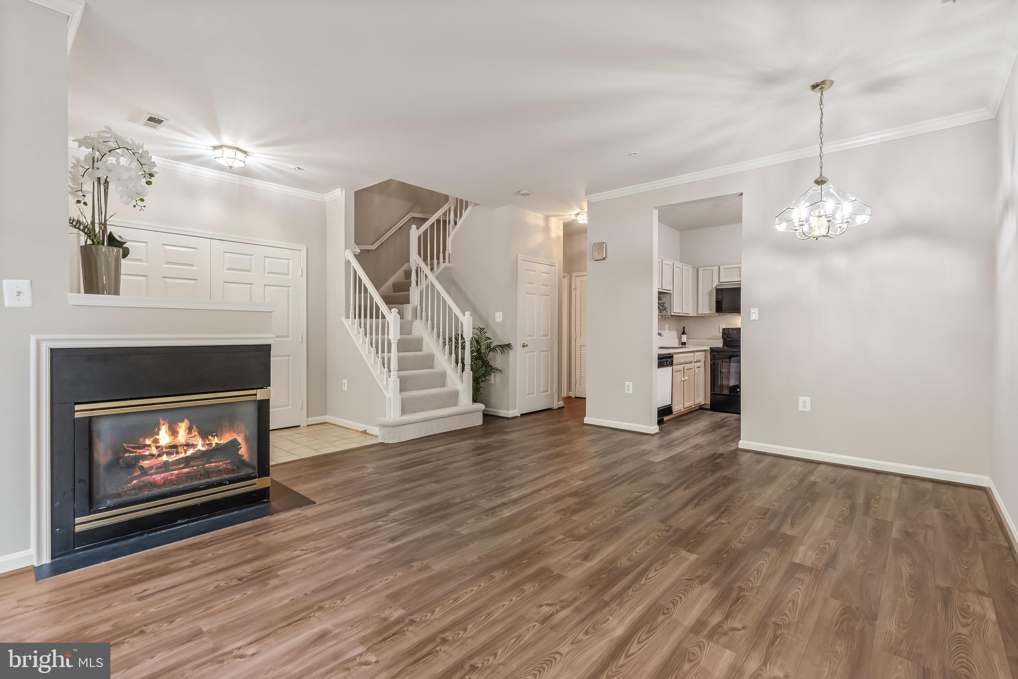 11408 Gate Hill Place, Unit 113 Reston, VA 20194 - Photo 8 of 30 a view of a livingroom with wooden floor a fireplace and window