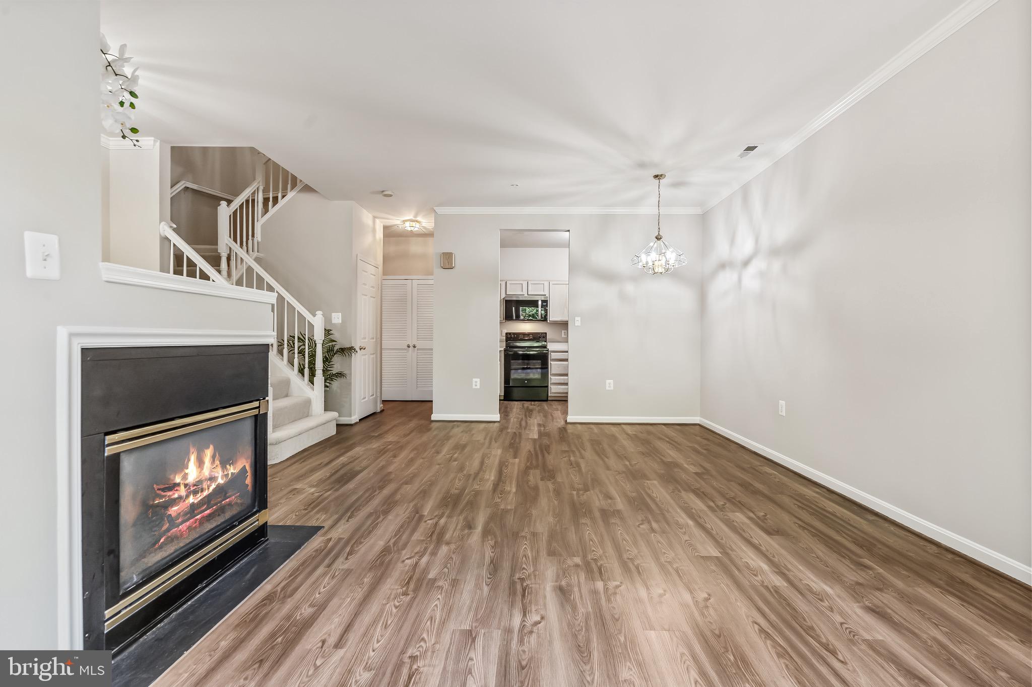 11408 Gate Hill Place, Unit 113 Reston, VA 20194 - Photo 9 of 30 a view of empty room with wooden floor and fireplace