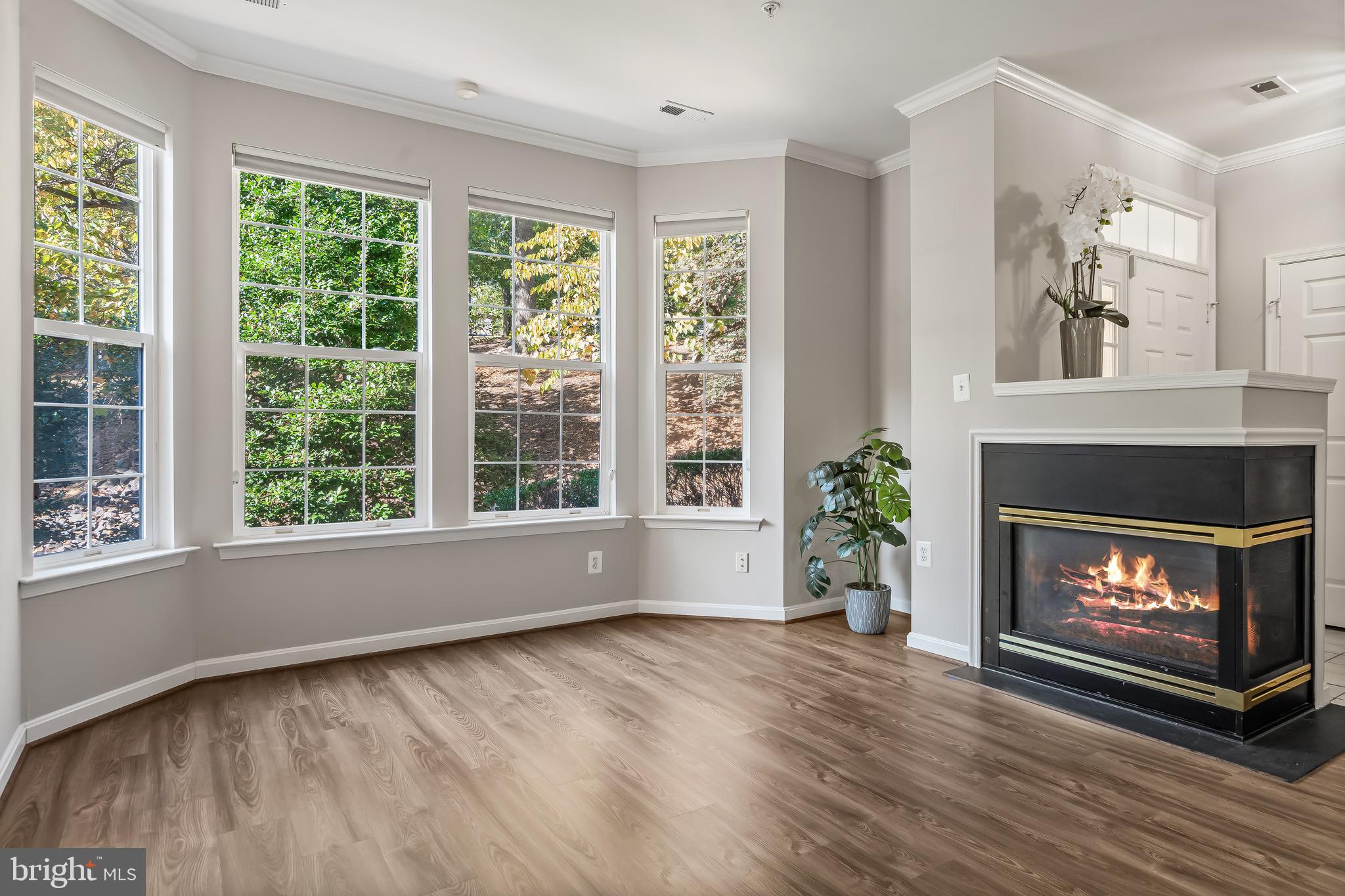 11408 Gate Hill Place, Unit 113 Reston, VA 20194 - Photo 10 of 30 a view of an empty room with wooden floor and a window