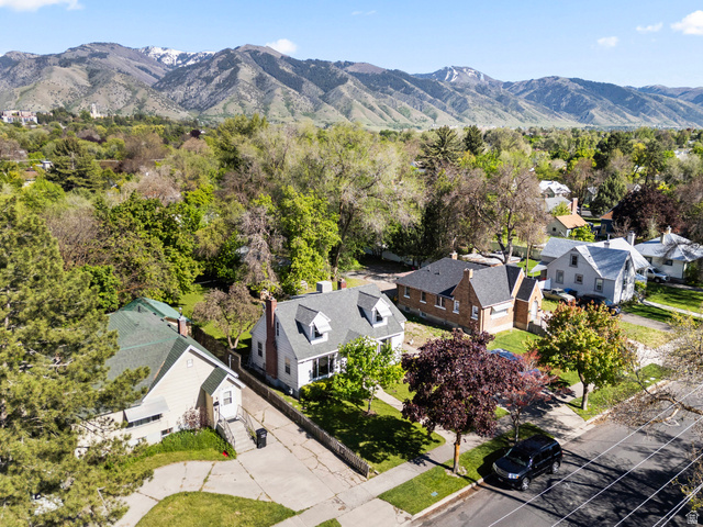 658 North 100 East Logan, UT 84321 - Photo 24 of 26 Aerial perspective showcasing a residential street with mature trees, green lawns, and diverse home architectural styles