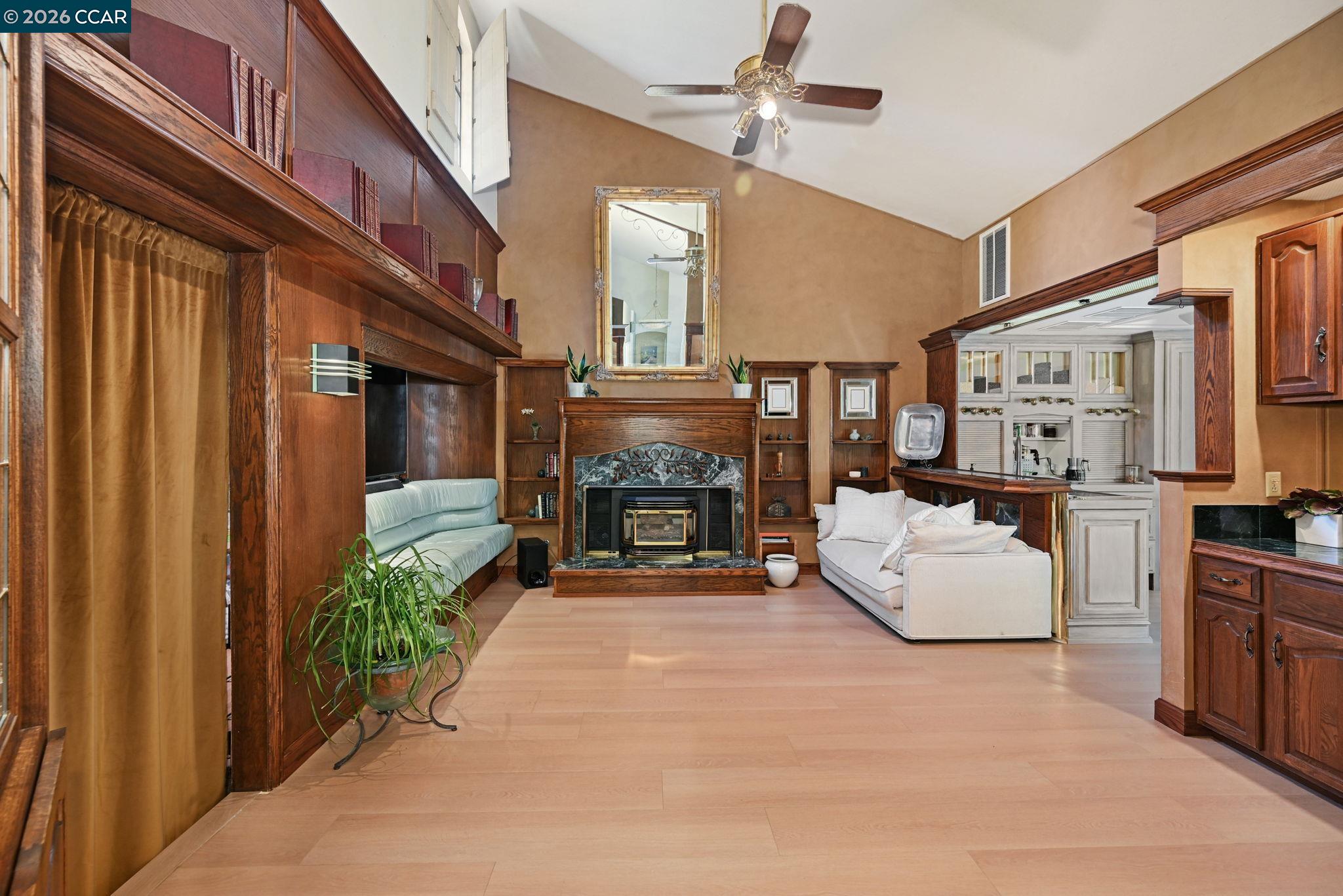 490 St Marys Road Lafayette, CA 94549 - Photo 17 of 61 a living room with furniture a fireplace and a chandelier