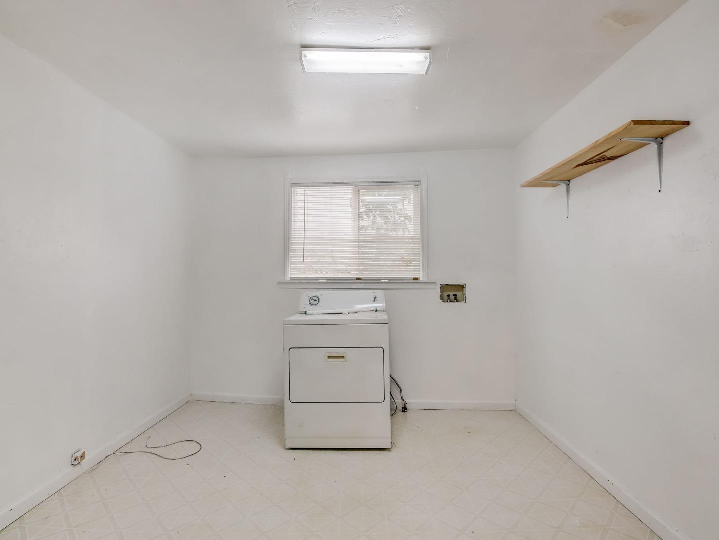 1164 Ocean Avenue Oakland, CA 94608 - Photo 12 of 32 an empty room with a stove and a window