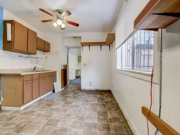 a kitchen with a stove a sink and a refrigerator