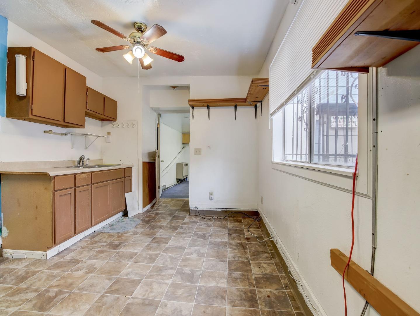 1164 Ocean Avenue Oakland, CA 94608 - Photo 17 of 32 a kitchen with a stove a sink and a refrigerator