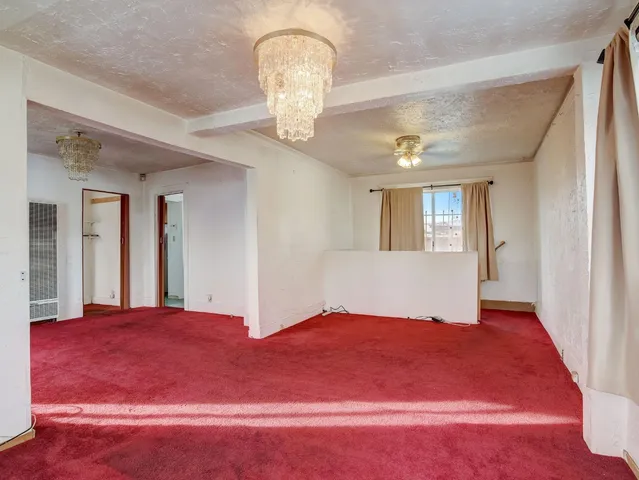 a bedroom with a large bed and chandelier