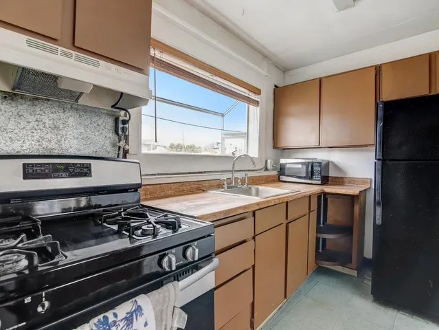 a kitchen with a stove and a refrigerator