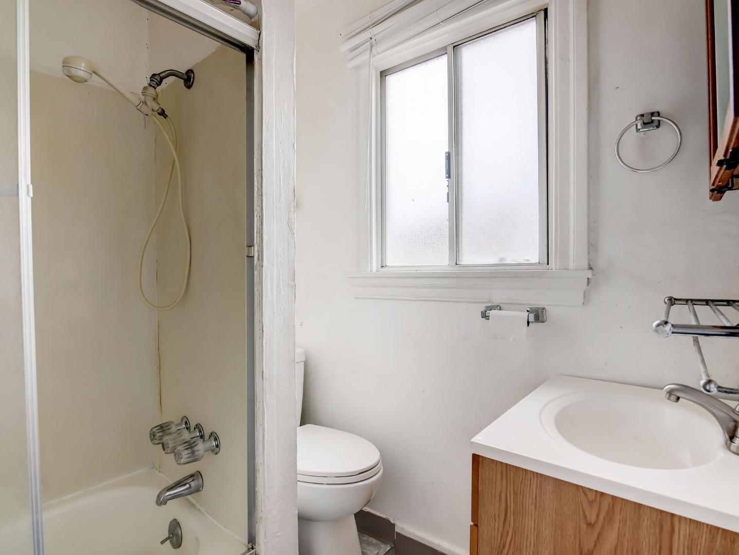 1164 Ocean Avenue Oakland, CA 94608 - Photo 22 of 32 a bathroom with a sink a toilet and shower