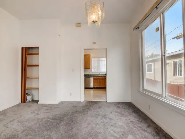 an empty room with windows and entrance