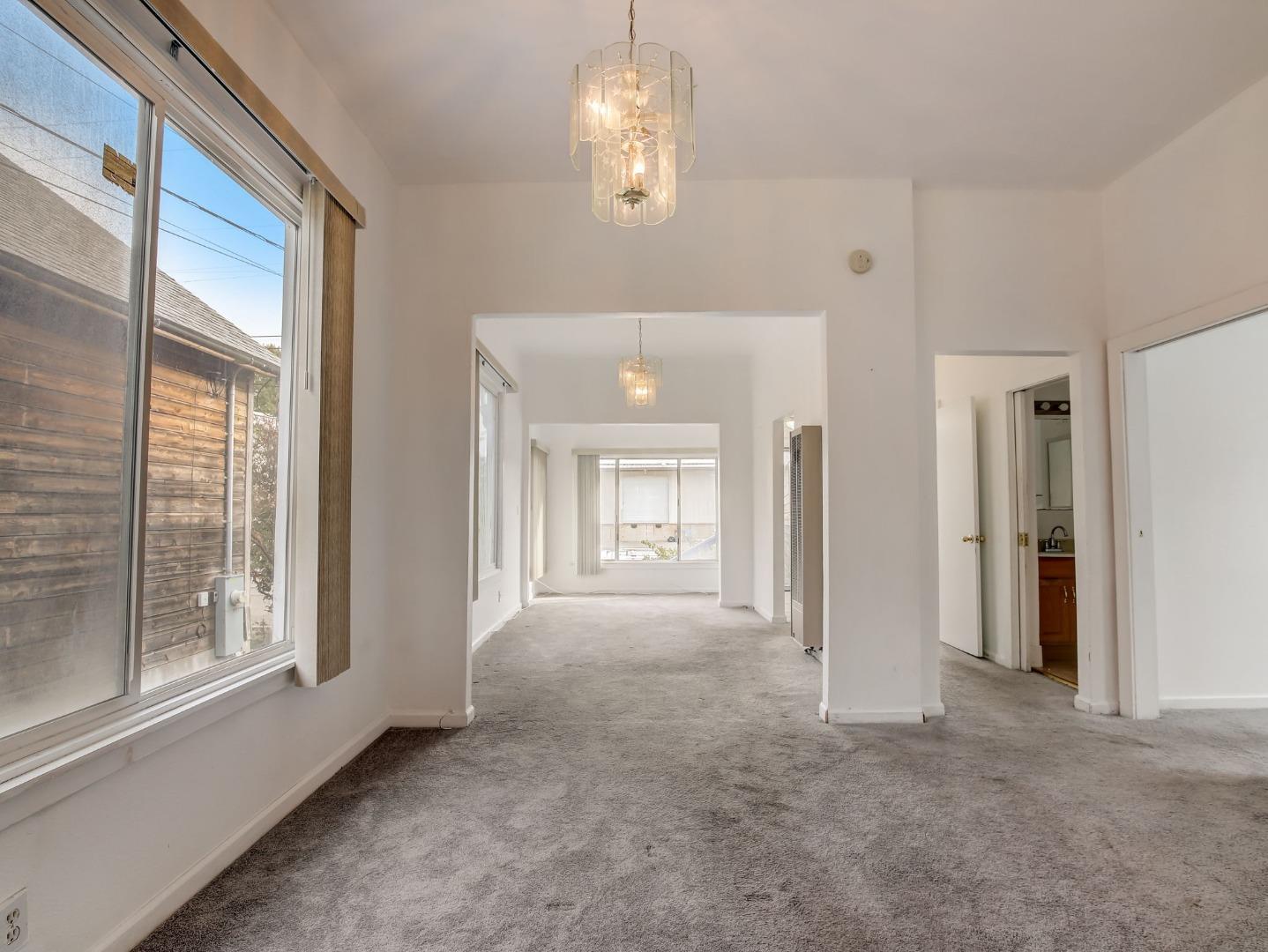 1164 Ocean Avenue Oakland, CA 94608 - Photo 6 of 32 a view of a big room with windows and chandelier