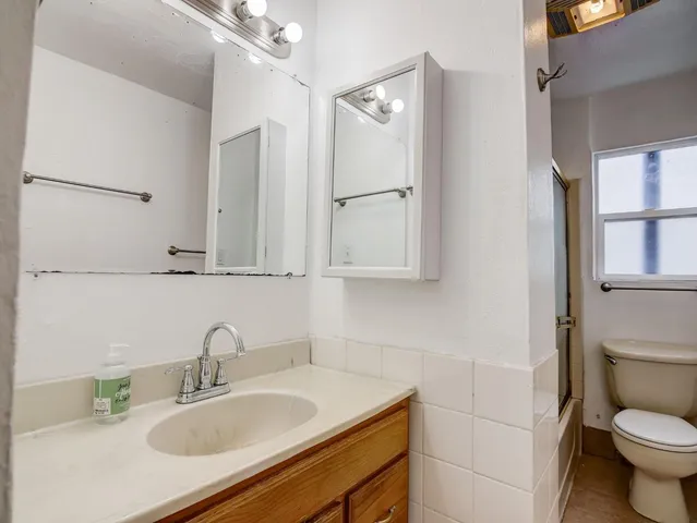a bathroom with a sink toilet and mirror