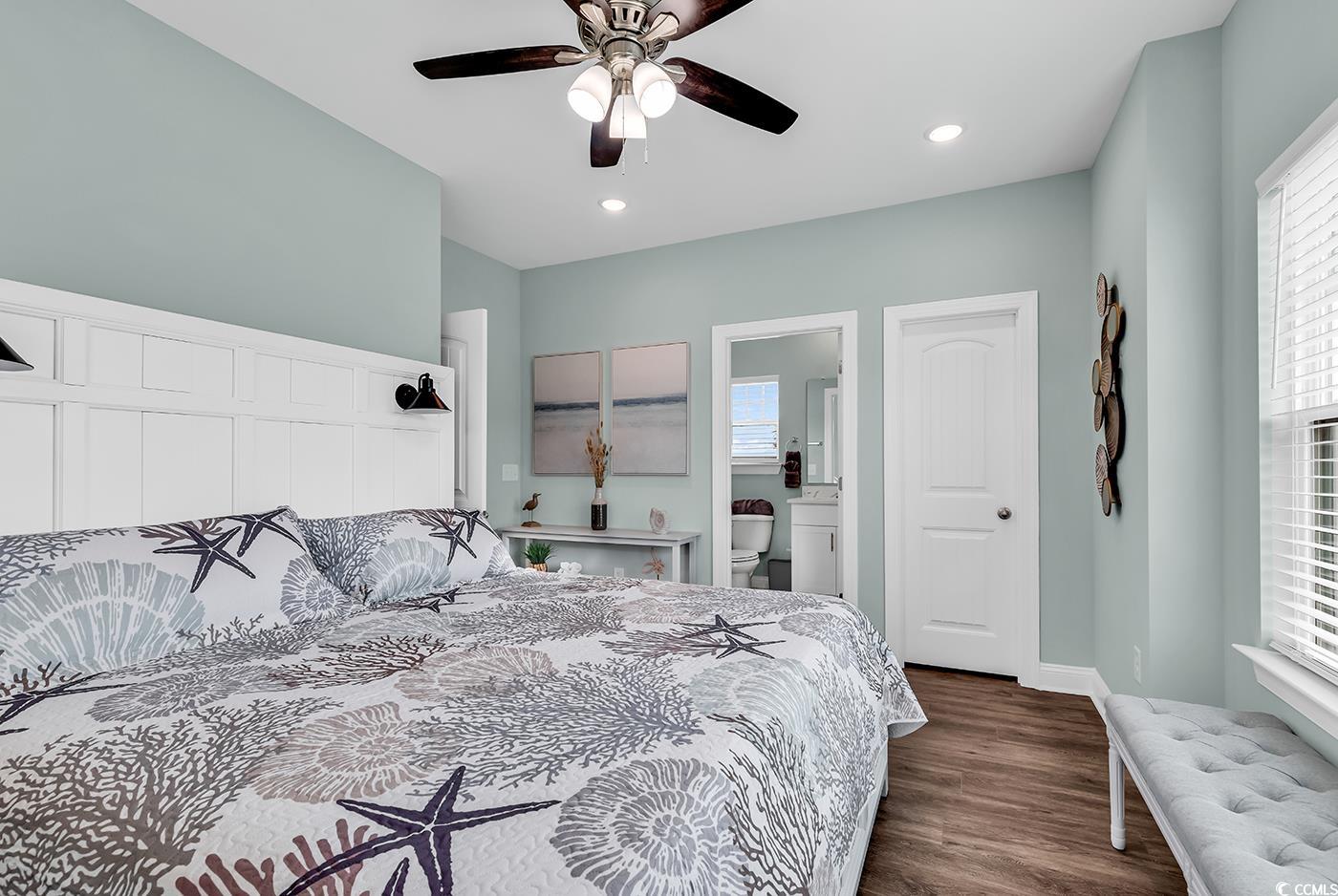 306 6th Avenue North Myrtle Beach, SC 29577 - Photo 13 of 28 Bedroom with multiple windows, dark wood finished floors, recessed lighting, ceiling fan, and connected bathroom