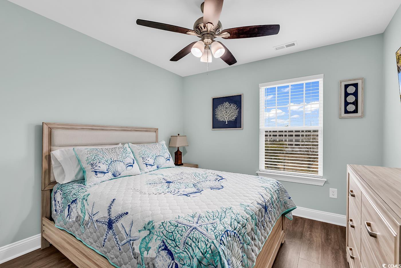 306 6th Avenue North Myrtle Beach, SC 29577 - Photo 18 of 28 Bedroom with dark wood-type flooring and ceiling fan