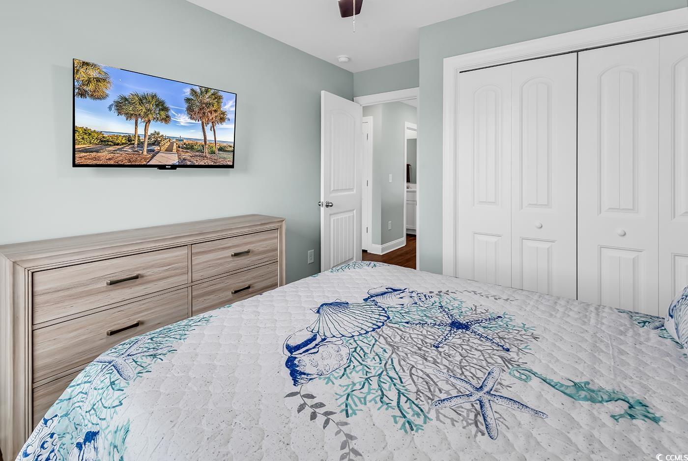 306 6th Avenue North Myrtle Beach, SC 29577 - Photo 19 of 28 Bedroom featuring a closet and a ceiling fan