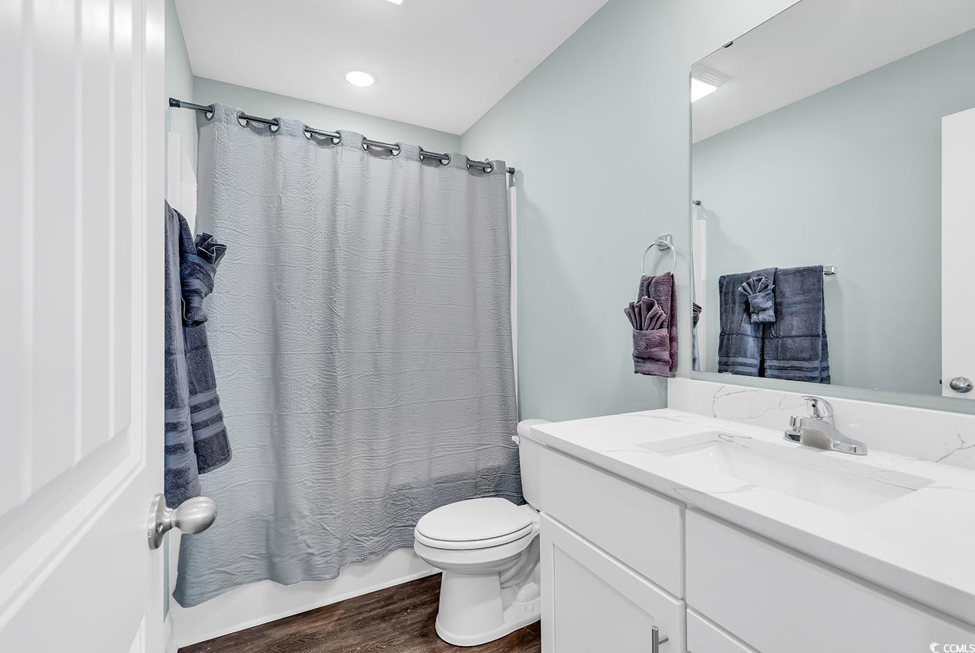 306 6th Avenue North Myrtle Beach, SC 29577 - Photo 20 of 28 Full bath featuring vanity, dark wood-type flooring, and shower / tub combo