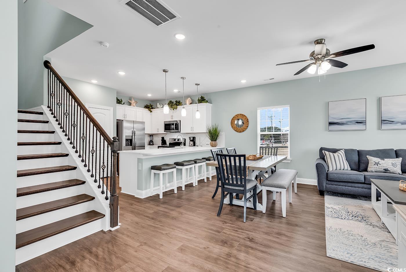 306 6th Avenue North Myrtle Beach, SC 29577 - Photo 3 of 28 Dining room with light wood finished floors, stairway, recessed lighting, and a ceiling fan