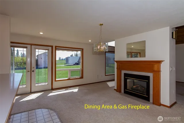 a view of an empty room with a fireplace