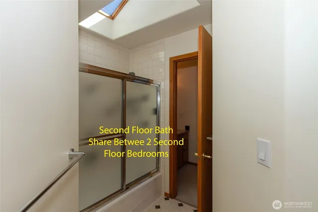 a bathroom with a glass shower door