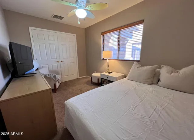 a bedroom with a bed and a chandelier