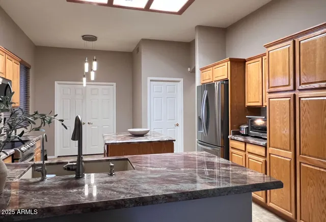 a kitchen with counter top space cabinets and stainless steel appliances