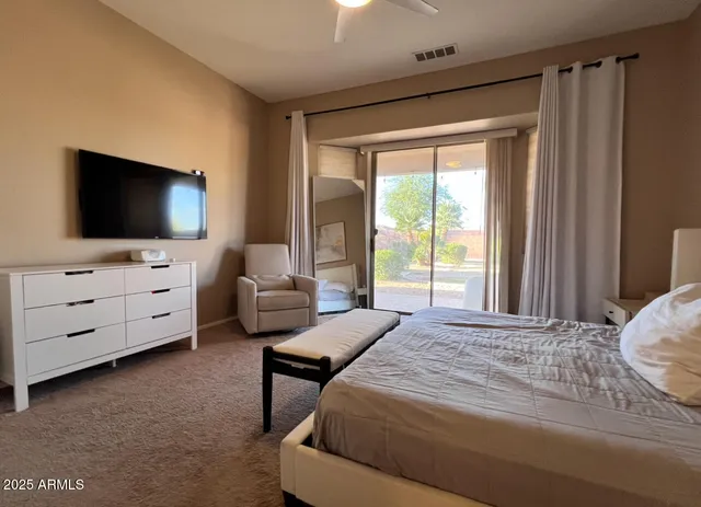 a bedroom with furniture and flat screen tv