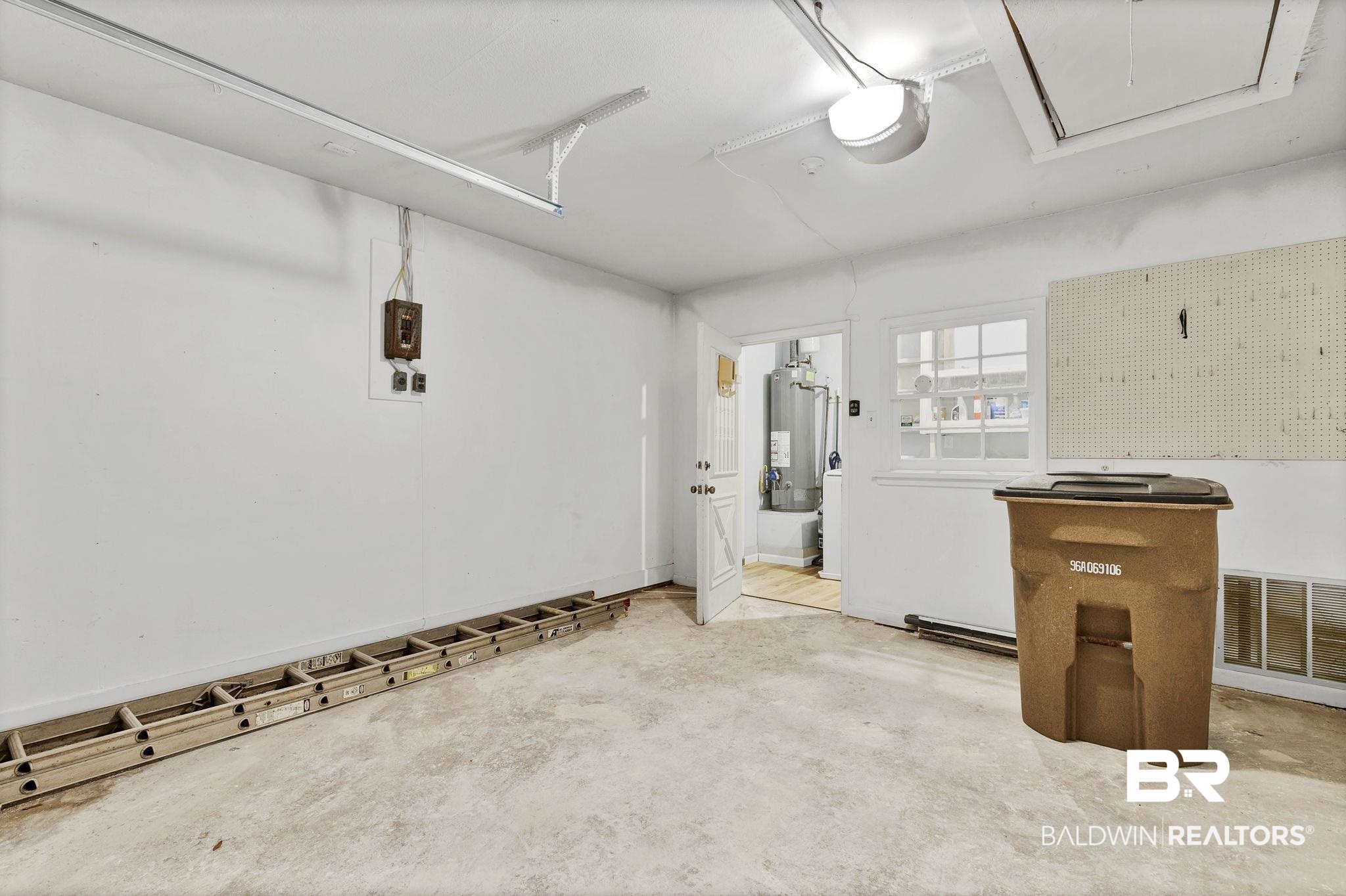 5817 Woodgate Road Mobile, AL 36609 - Photo 63 of 85 Parking deck with a garage door opener, water heater, and visible vents