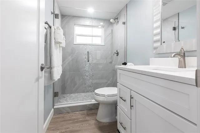 a bathroom with a sink toilet and shower
