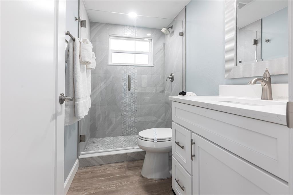 6020 Midnight Pass Road, Unit 53 Sarasota, FL 34242 - Photo 12 of 16 a bathroom with a sink toilet and shower