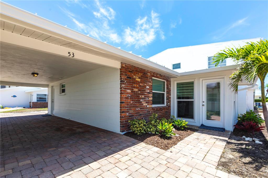 6020 Midnight Pass Road, Unit 53 Sarasota, FL 34242 - Photo 13 of 16 a front view of a house with garden