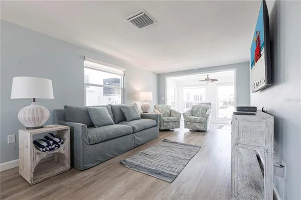 a living room with furniture a rug and a flat screen tv