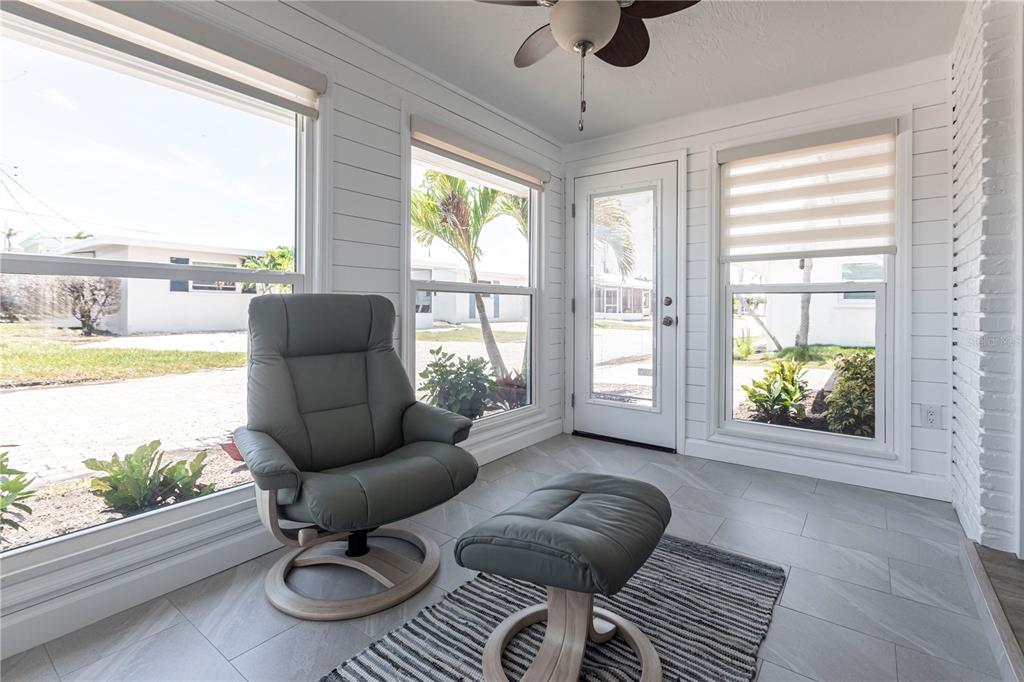 6020 Midnight Pass Road, Unit 53 Sarasota, FL 34242 - Photo 6 of 16 a living room with furniture and a floor to ceiling window