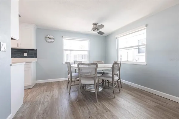 a dining room with wooden floor and a window