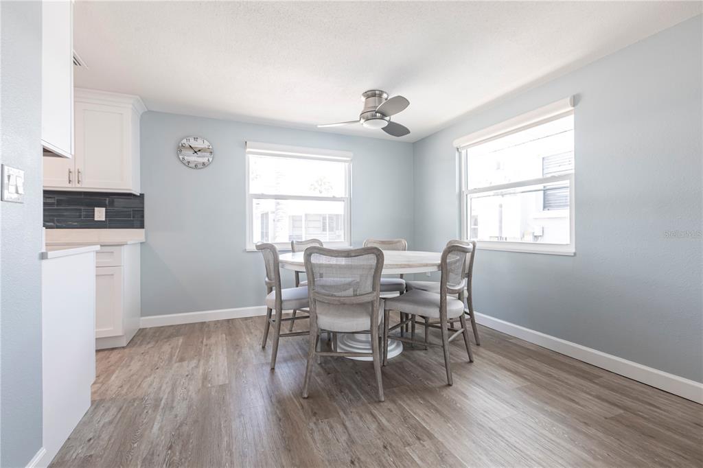 6020 Midnight Pass Road, Unit 53 Sarasota, FL 34242 - Photo 7 of 16 a dining room with wooden floor and a window
